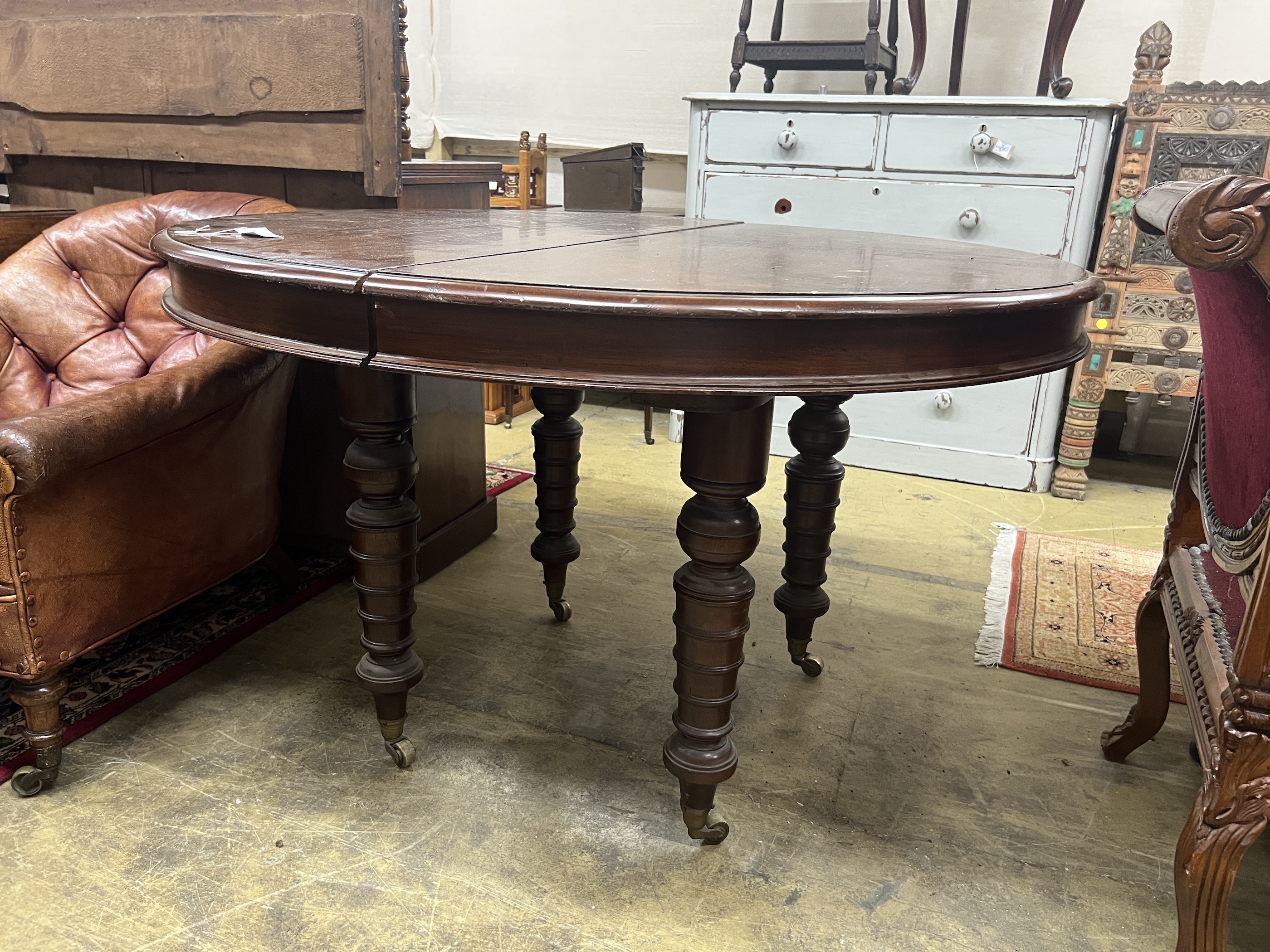A 19th century and later Continental mahogany circular extending dining table, length approx. 270cm extended, three spare leaves, width 122cm, height 76cm